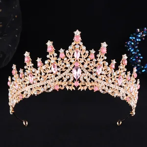 Elegant rose gold bridal crown with pink crystals and white rhinestones on black background