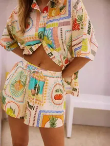 Detail of summer two-piece set featuring stamp-style fruit prints and drawstring waist