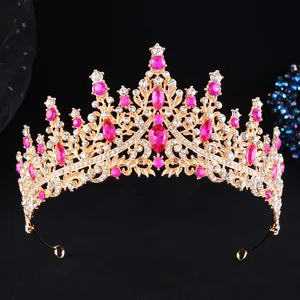 Detailed close-up of golden crown with rose pink gemstones and sparkling rhinestones
