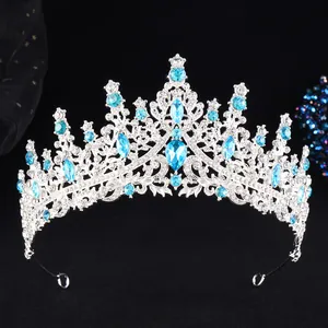 Macro shot of silver bridal crown featuring blue crystals and intricate hollow metalwork