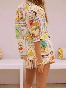Detail of tropical fruit stamp prints on short sleeve shirt and shorts summer set