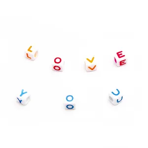 Macro shot of white cube alphabet beads spelling LOVE YOU for DIY jewelry making