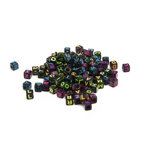 Macro shot of 6x6mm square black acrylic alphabet beads with colorful A-Z lettering