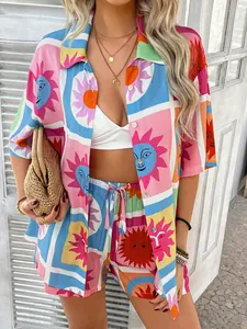 Detail of colorful plaid shirt and shorts set featuring sun face patterns and drawstring waist