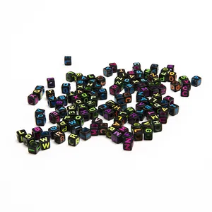 Macro shot of 6mm black square acrylic beads with colorful A-Z alphabet engravings