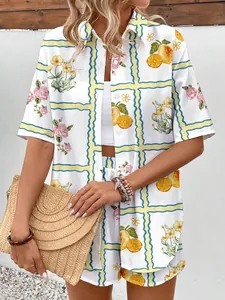 Detail of summer vacation set with lemon and rose print on button-up shirt and shorts