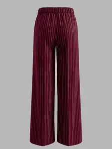 Detail of high waisted burgundy wide leg trousers featuring white vertical pinstripe pattern