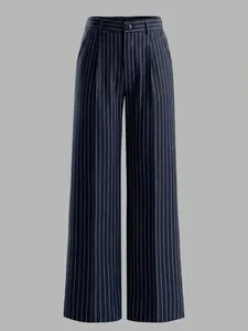 Detail of high-waist striped wide-leg pants showing texture and vertical white stripes