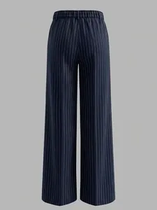 Detail of high waist elastic waistband and fine vertical stripes on navy wide-leg trousers