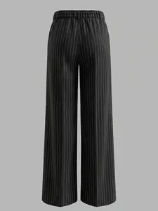 Back view of high waisted pinstripe wide leg trousers in black and white stripes