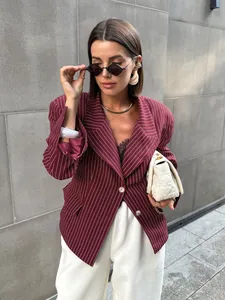 Detail of burgundy pinstripe blazer featuring notched lapels and white buttons