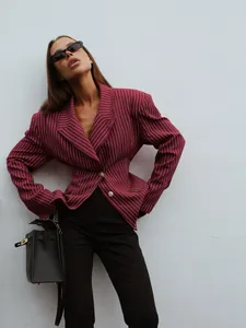 Close-up of slim-fit pinstripe blazer featuring peak lapels and sharp waist tailoring