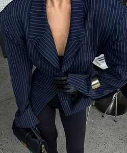 Detail of slim-fit navy pinstripe blazer with sharp padded shoulders and notch lapel