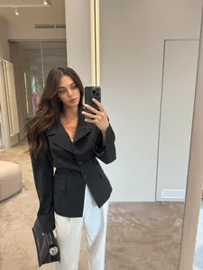 Mirror selfie showing a black pinstripe slim fit blazer with waist-shaping design