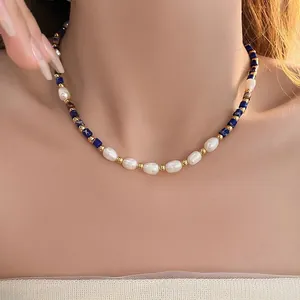 Close-up of rice-shaped freshwater pearls and blue lapis lazuli beads on a gold necklace