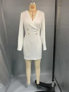 Close-up of white long sleeve dress with V-neck and decorative gold double-breasted buttons