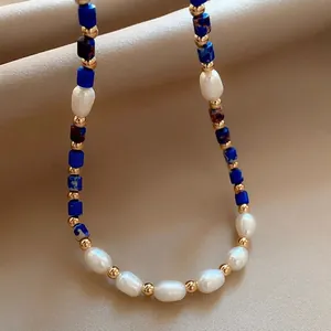 Detail of freshwater pearl and lapis lazuli necklace with golden metallic spacer beads