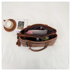 Close-up of brown retro tote bag interior showing spacious three-layer compartments