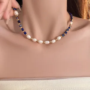 Close-up of freshwater pearls and lapis lazuli beads necklace worn on a collarbone