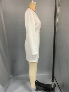 Side view of white long sleeve v-neck business dress with gold side buttons