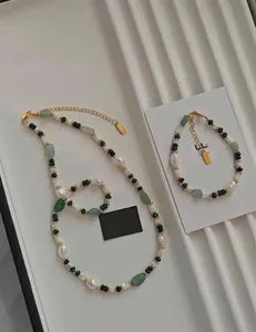 Detail of green aventurine beads and baroque pearls on necklace and bracelet set