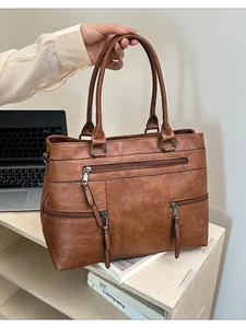 Vintage brown leather tote bag with triple front zippers and large capacity for daily use