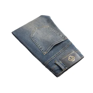 Slim fit vintage blue jeans for men with leather waist patch and retro washed finish