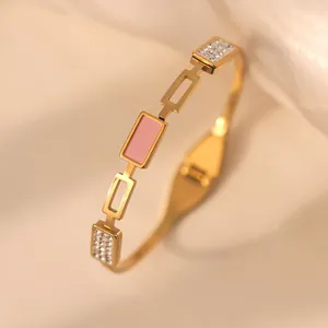 Detail of 18k gold plated bangle with pink enamel modules and sparkling zircon accents