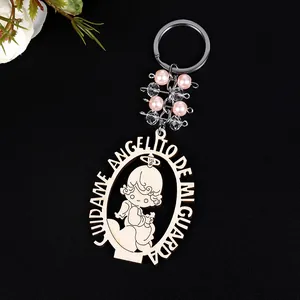 Detail of wooden angel keychain with pink beads and Spanish guardian angel engraving
