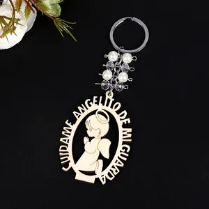Detail of wooden angel keychain with white faux pearls and silver metal chain link