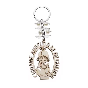 Detail of wooden angel keychain with pearls, crystal beads and Spanish engraving