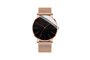 Detail of rose gold mesh strap and black dial with red hour markers on a quartz watch