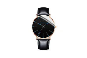 Detail of rose gold watch case with minimalist black dial and luminous blue hands