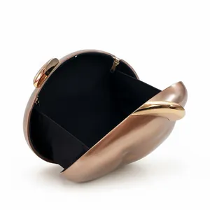 Detail view of acrylic evening clutch featuring rose gold brushed finish and black lining