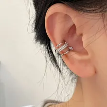 Close-up of silver-plated ear cuff set featuring micro-pave crystals and bead details