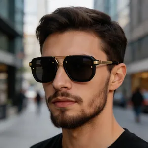 Close-up of men's square frame sunglasses with golden double bridge on a male model