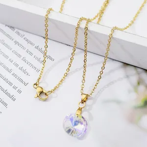 Gold stainless steel necklace with multifaceted iridescent heart crystal pendant on white frame
