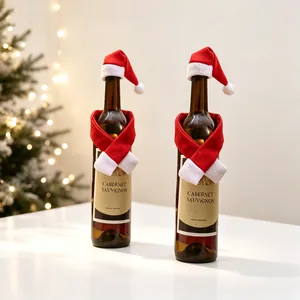 Detailed view of red Christmas hat and scarf set decorating a wine bottle on a festive table