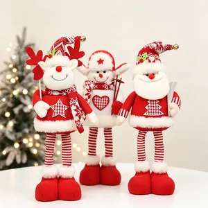 Detail of Christmas sitting plush figurines with knitted textures and bell decorations