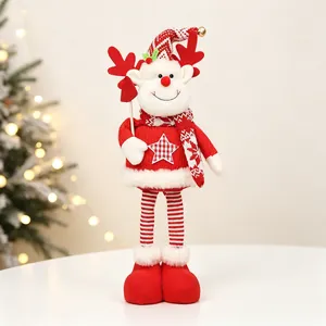Close-up of knit Christmas plush doll with star detail and holiday tree background