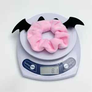 Weight measurement of the pink plush bat wing scrunchie for Halloween