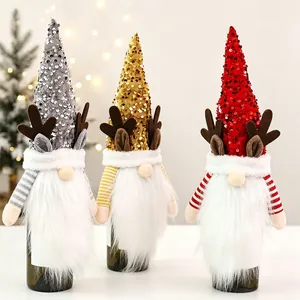 Detailed view of three gnome wine bottle covers with sequined antler hats in festive colors