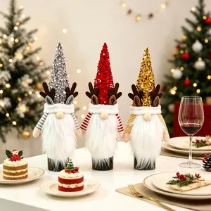 Close-up of sequined gnome wine bottle covers with reindeer antlers for Christmas table decor