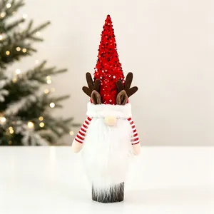 Close-up of a Christmas gnome wine bottle cover with red sequin hat and reindeer antlers