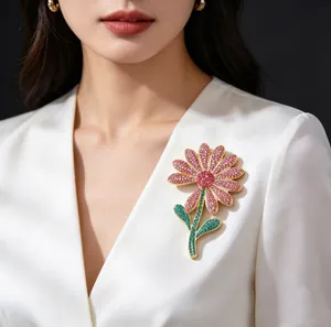 Close-up of a luxury flower brooch with pink rhinestones pinned to a white blazer lapel