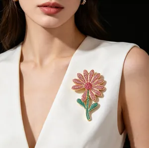 Close-up of luxury flower brooch with pink rhinestones on a white V-neck garment