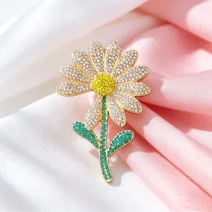 Luxury daisy flower brooch pin with sparkling white and yellow crystals on gold setting
