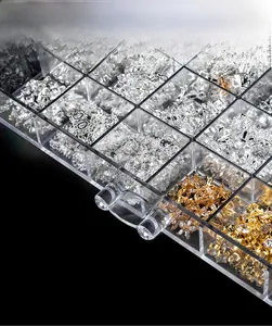 Close-up of clear acrylic nail art storage box with drawer handles and metal accessories