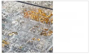 Macro view of clear acrylic drawer handles on a multi-layer jewelry storage box
