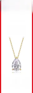 Detail of pear-cut moissanite pendant on a 925 sterling silver gold plated chain